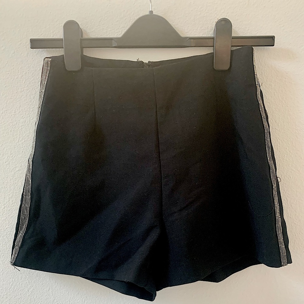 Black hot pants. Short shorts have silver beaded accent stripe on sides.